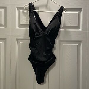 Women’s one piece tummy control black bathing suit. Worn once.